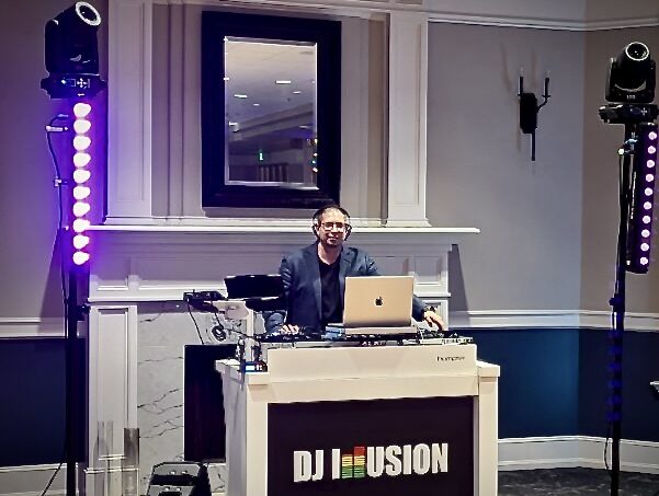 DJ Illusion Signature holiday package with sixteen wireless uplights transforming an event venue