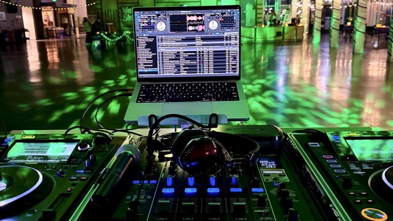 Pioneer CDJs, a mixer, and a laptop at a green-lit Seattle event
