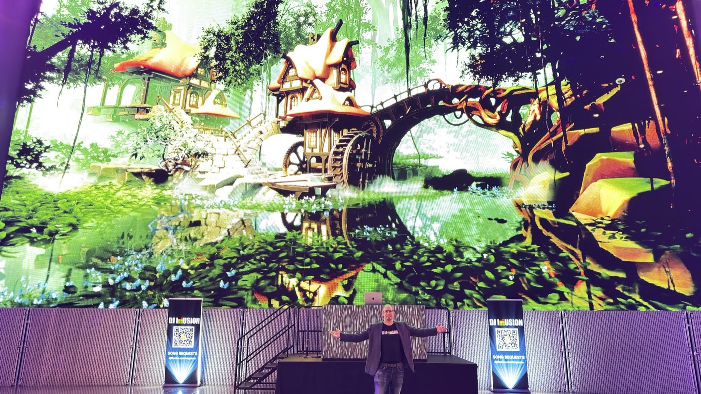 DJ Illusion performing live in front of a giant LED video wall