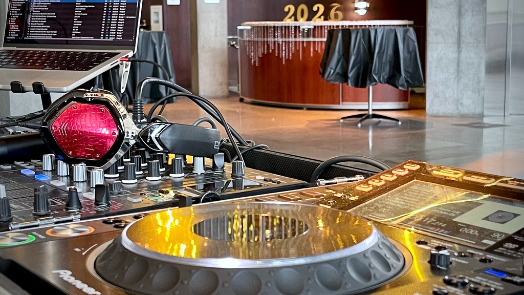 DJ Illusion running a New Year's Eve countdown with club lighting and a packed dance floor