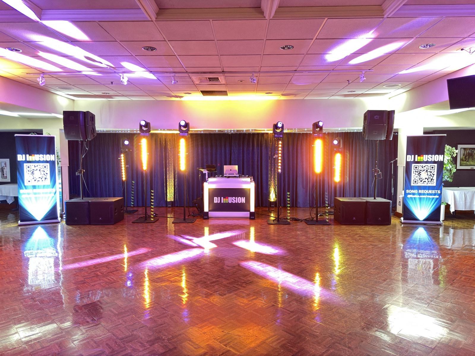 DJ Illusion Club-Style package in ballroom with full uplighting, moving heads, and parquet dance floor