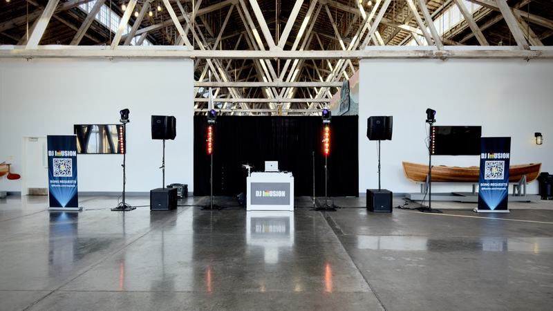 DJ Illusion Premier package setup with four lighting totems and JBL sound system in large event venue
